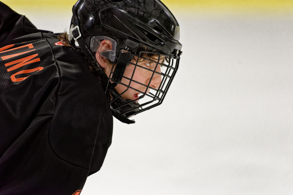 Focused young ice hockey player on the rink.